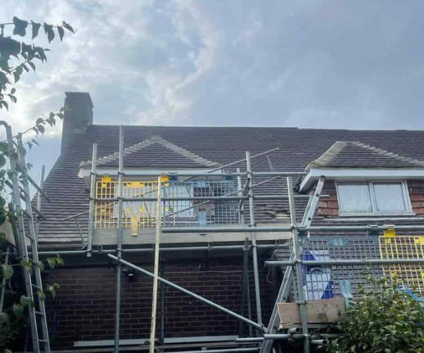 This is a photo of a roof with two dormers that is having some damaged tiles replaced. Works carried out by SM Roofing Hatfield