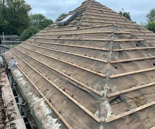 This is a photo of a hip roof that has been stripped back to the battens, and is awaiting a new roof covering to be installed. Works carried out by SM Roofing Hatfield